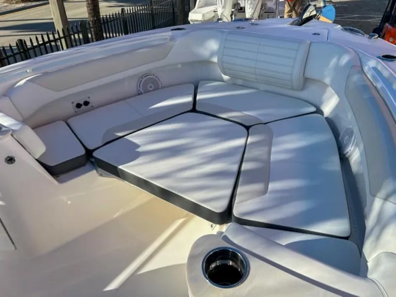 Slide: The Image of 2025 Edgewater 262CC boat interior with cushioned seating and cup holder. - 15
