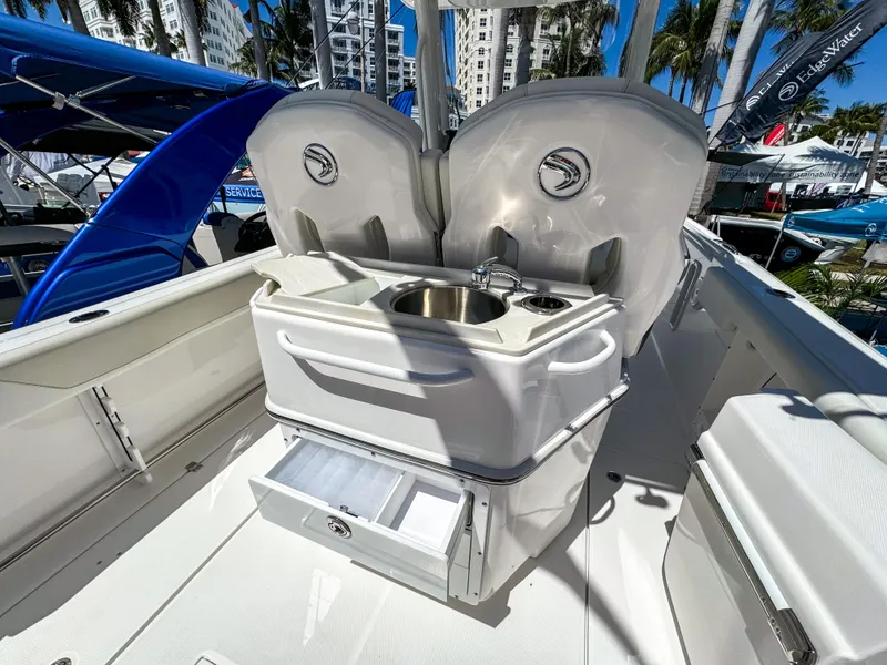 Slide: The Image of 2025 Edgewater 262CC boat interior with sink and storage, showcasing modern design and functionality. - 20