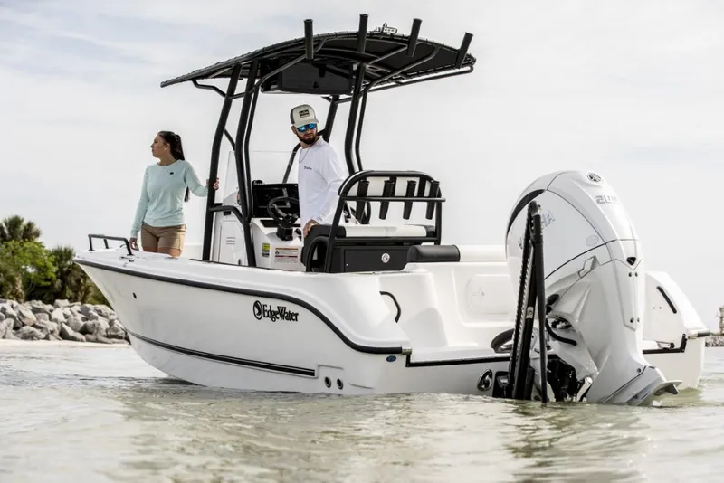 Slide: The Image of 2025 Edgewater 208CC Watchman boat in shallow water with two people onboard. - 7