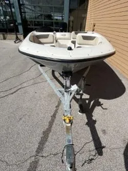 Slide: The Image of 2017 Bayliner Element E16 boat on trailer, parked outdoors. - 3