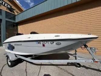 Slide: The Image of 2017 Bayliner Element E16 boat on trailer, parked outdoors. - 4