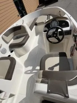 Slide: The Image of 2017 Bayliner Element E16 boat interior with seating and steering wheel. - 6