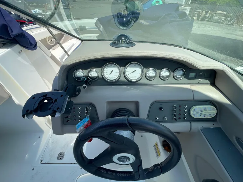 Slide: The Image of 2004 Cobalt 226 boat dashboard with steering wheel and instrument panel. - 13
