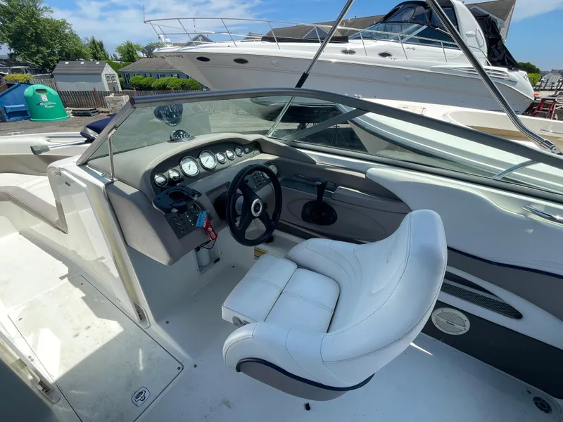 Slide: The Image of 2004 Cobalt 226 boat interior with steering wheel and dashboard controls. - 15