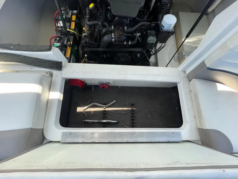 Slide: The Image of Engine compartment of a 2004 Cobalt 226 boat with tools and components visible. - 24