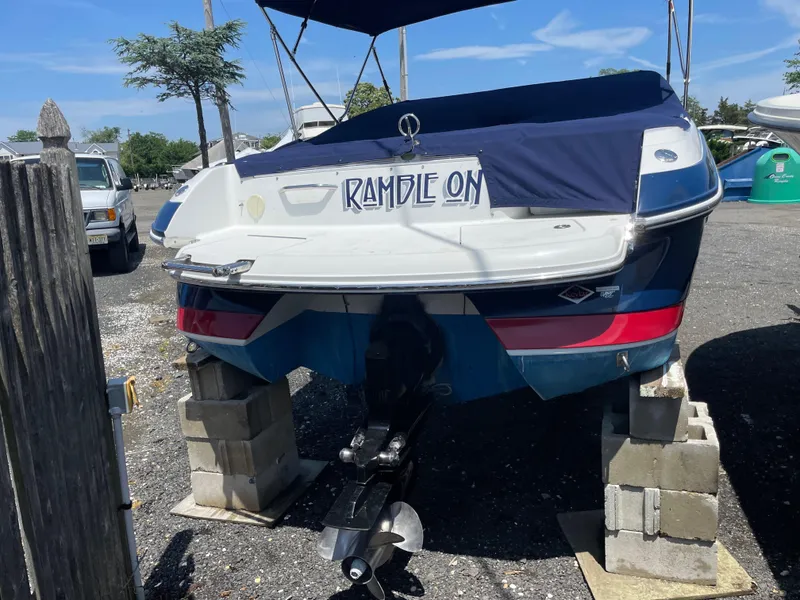 Slide: The Image of 2004 Cobalt 226 boat on blocks, rear view with "Ramble On" text. - 27