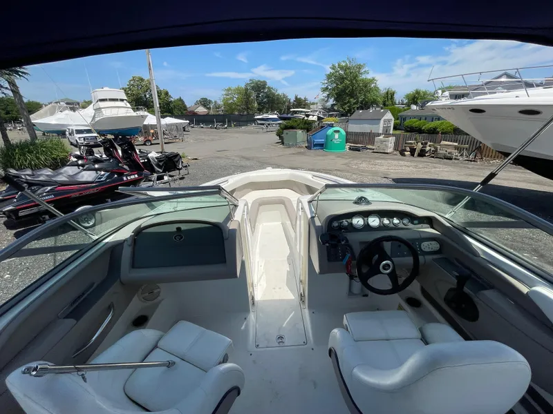 Slide: The Image of Interior view of a 2004 Cobalt 226 boat with dashboard and seating. - 9