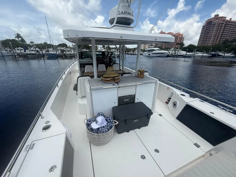 Slide: The Image of 2017 Axopar 37 Sun Top boat docked at marina, featuring spacious deck and modern amenities. - 10