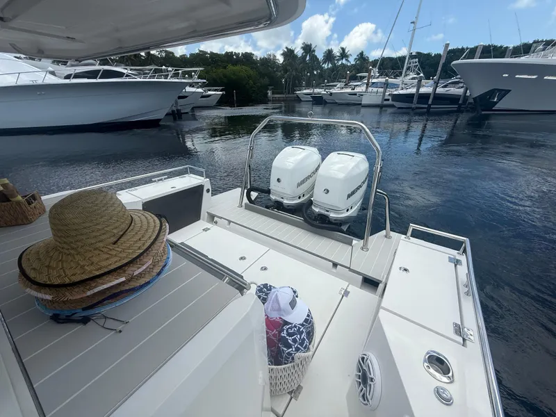 Slide: The Image of 2017 Axopar 37 Sun Top boat with twin Mercury engines docked at marina. - 12