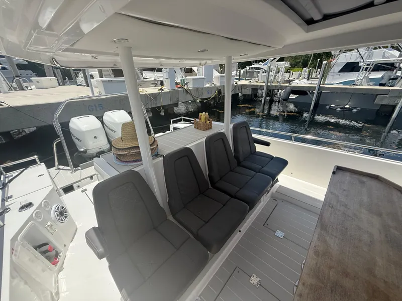 Slide: The Image of 2017 Axopar 37 Sun Top boat interior with seating and dock view. - 15