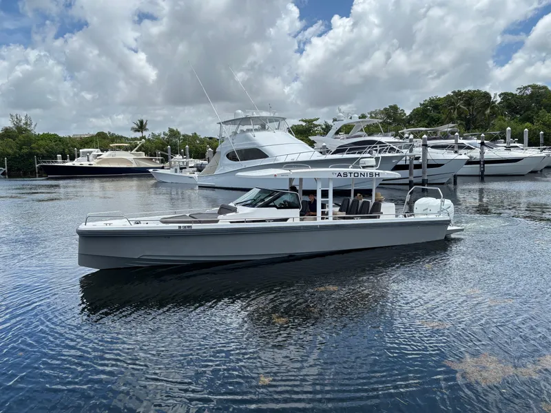 Slide: The Image of 2017 Axopar 37 Sun Top boat cruising in a marina with other yachts. - 2