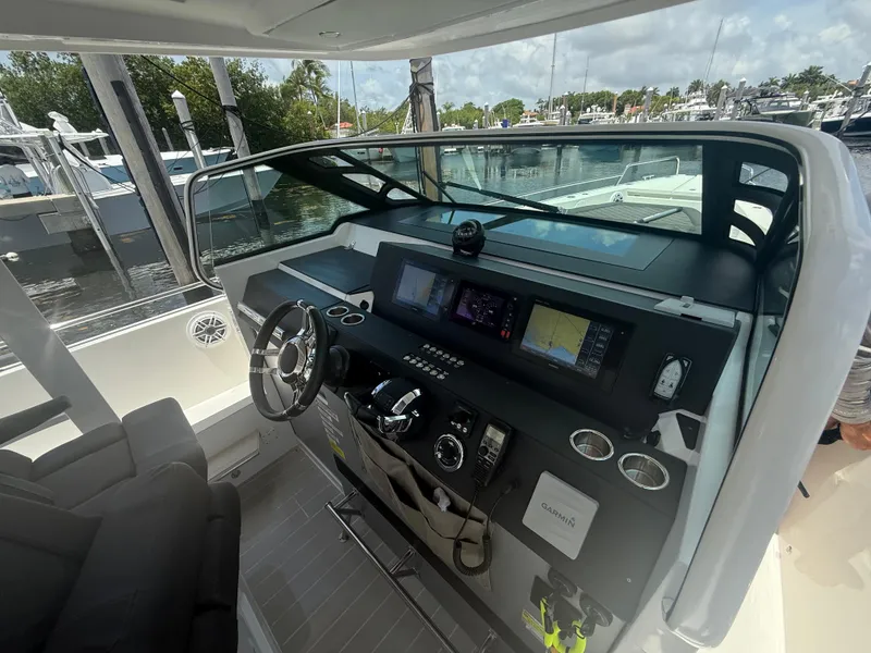 Slide: The Image of Cockpit of 2017 Axopar 37 Sun Top with modern navigation equipment and steering wheel. - 20