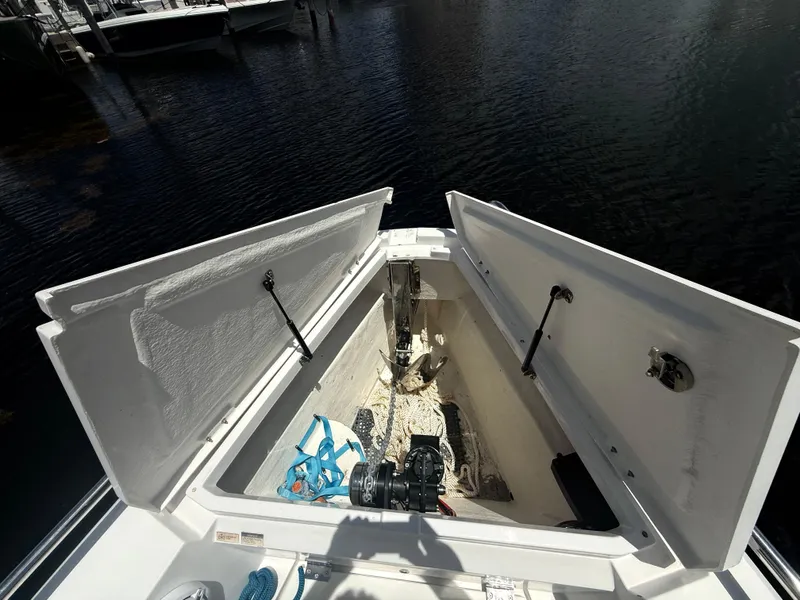 Slide: The Image of Open storage compartment on 2017 Axopar 37 Sun Top boat, showing anchor and ropes. - 26