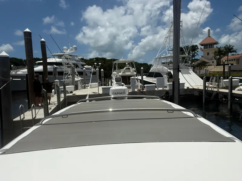 Slide: The Image of 2017 Axopar 37 Sun Top docked at a marina under a partly cloudy sky. - 31