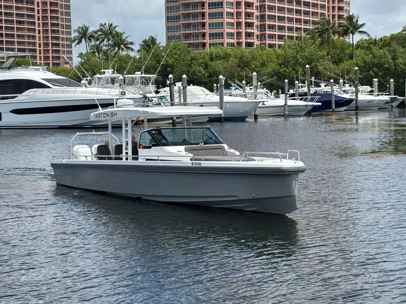 Slide: The Image of 2017 Axopar 37 Sun Top boat docked in marina with luxury yachts. - 4