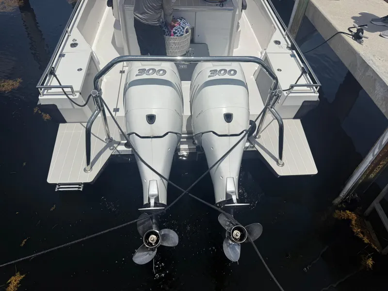 Slide: The Image of 2017 Axopar 37 Sun Top with twin 300 horsepower outboard engines at dock. - 7