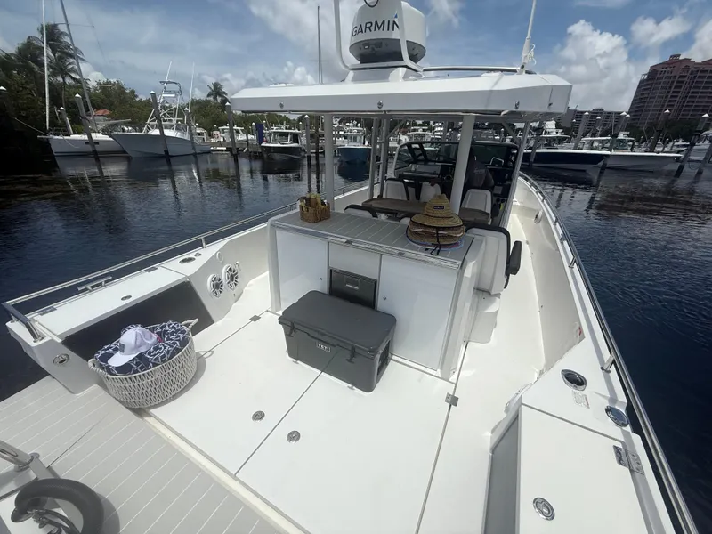 Slide: The Image of 2017 Axopar 37 Sun Top boat docked, featuring spacious deck and modern amenities. - 8