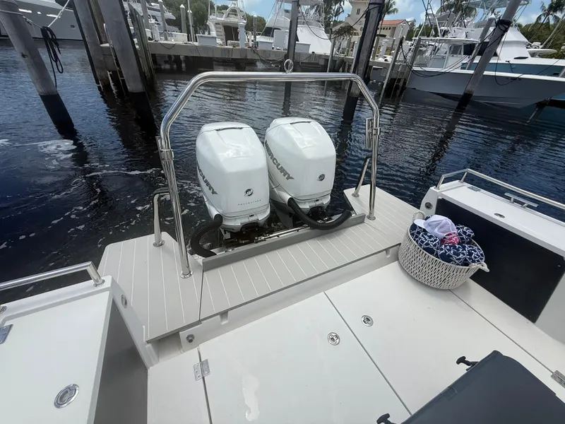 Slide: The Image of 2017 Axopar 37 Sun Top with twin Mercury outboard engines at a marina. - 9
