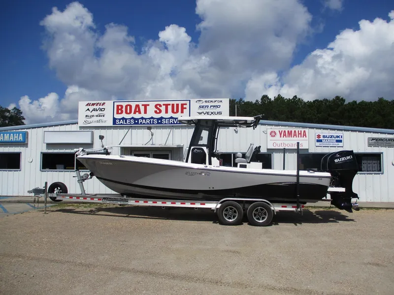 The Image of 2024 Blue Wave 2800 Makaira boat on trailer at dealership under cloudy sky. - 0