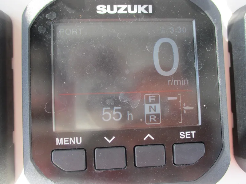 Slide: The Image of Suzuki engine display on 2024 Blue Wave 2800 Makaira, showing 55 hours and 0 RPM. - 12