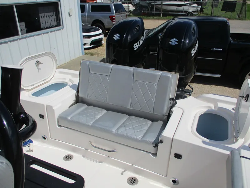 Slide: The Image of 2024 Blue Wave 2800 Makaira boat with dual Suzuki engines and cushioned seating. - 19