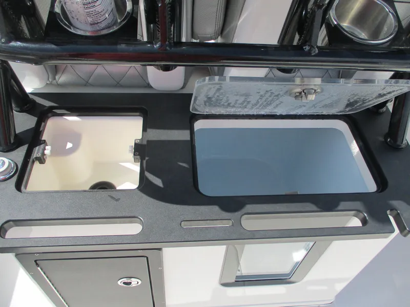 Slide: The Image of 2024 Blue Wave 2800 Makaira boat interior with storage compartments and cup holders. - 22