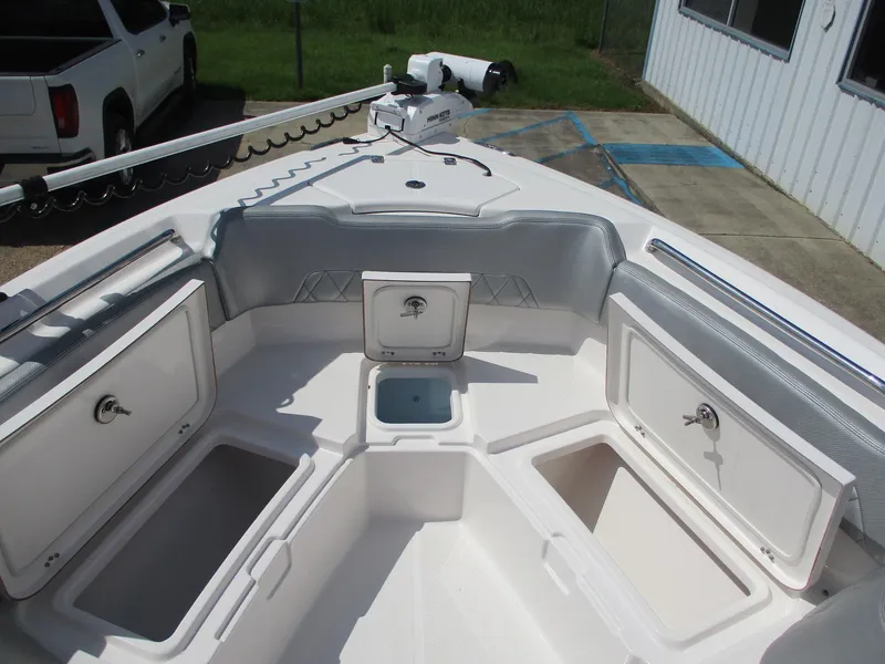 Slide: The Image of 2024 Blue Wave 2800 Makaira boat interior with storage compartments and seating. - 28