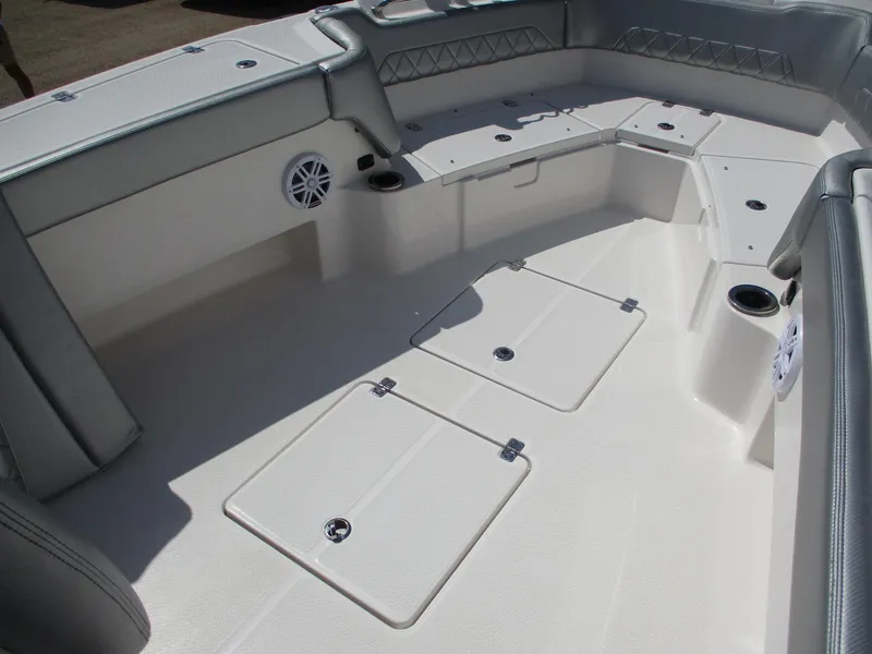 Slide: The Image of 2024 Blue Wave 2800 Makaira boat interior with storage compartments and seating. - 30