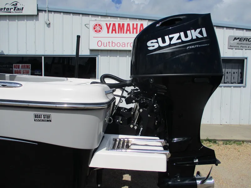 Slide: The Image of 2024 Blue Wave 2800 Makaira boat with Suzuki outboard motor at dealership. - 5