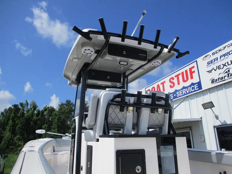 Slide: The Image of 2024 Blue Wave 2800 Makaira boat at dealership, clear sky background. - 6