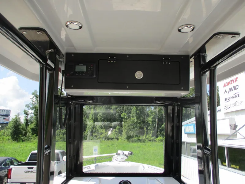 Slide: The Image of 2024 Blue Wave 2800 Makaira boat interior with control panel and scenic view. - 7