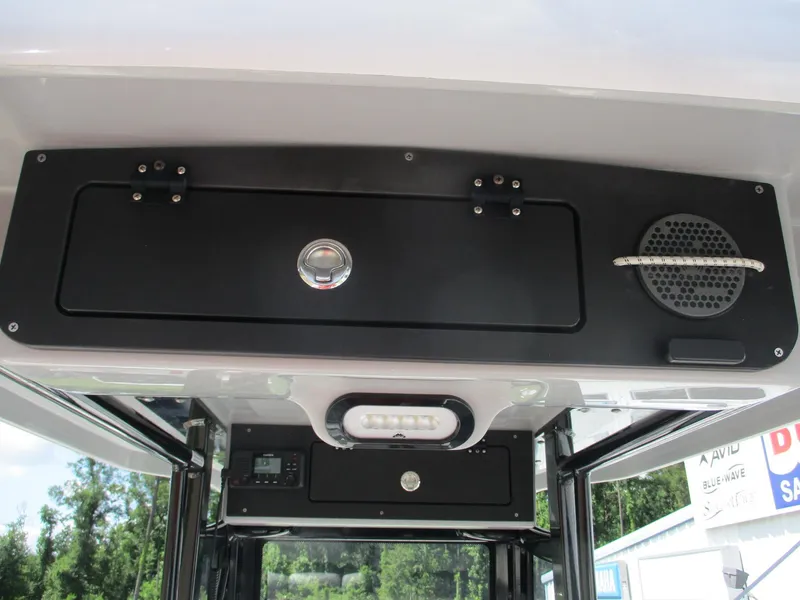 Slide: The Image of 2024 Blue Wave 2800 Makaira boat interior with storage compartment and speaker. - 8