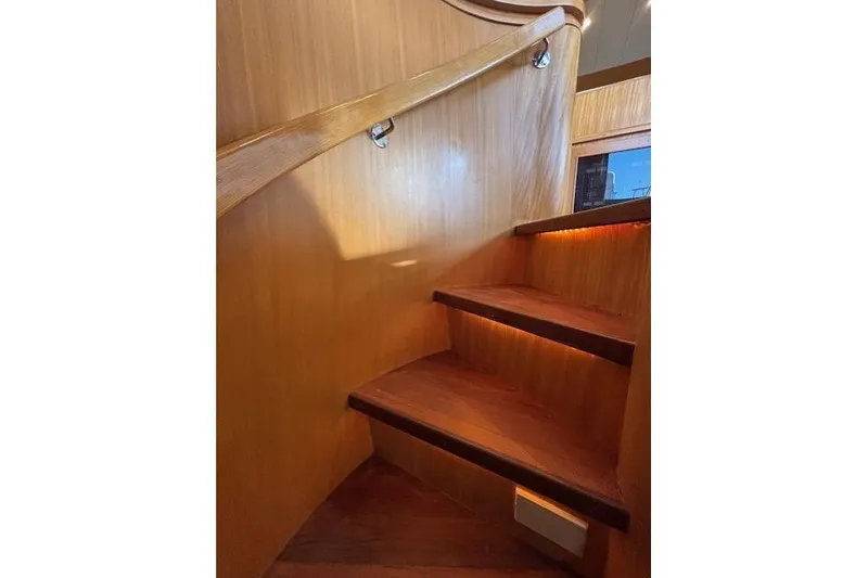 Slide: The Image of Wooden staircase inside 1994 Johnson High Tech Euro 56 yacht, featuring elegant design and lighting. - 21