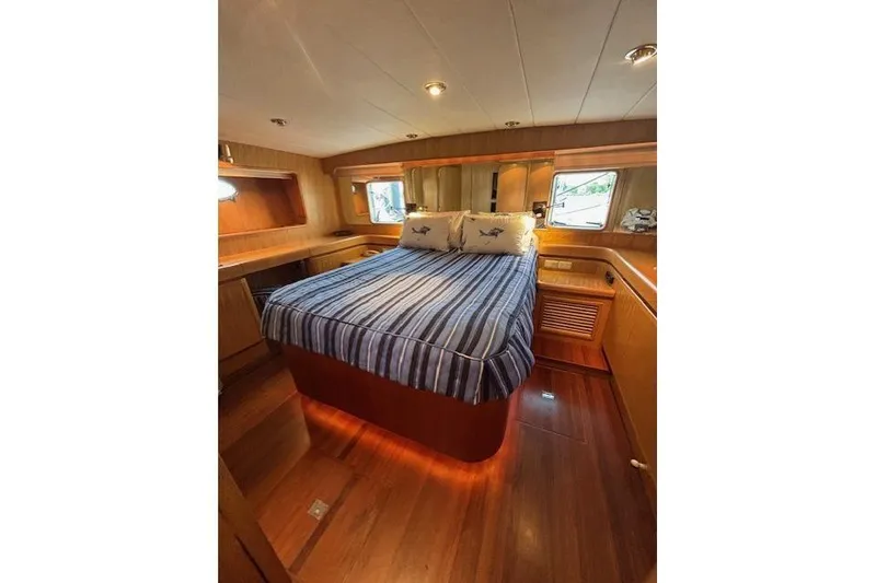 Slide: The Image of Luxurious cabin interior of 1994 Johnson High Tech Euro 56 yacht with striped bedding. - 22
