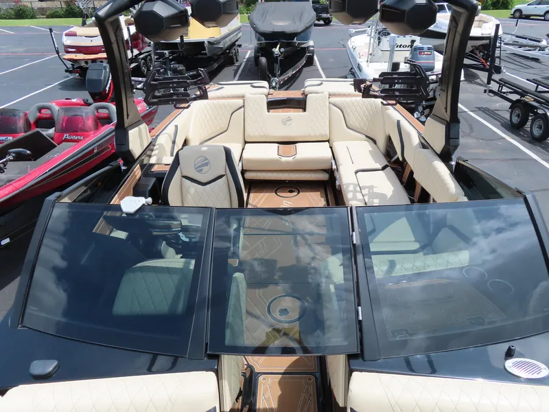 Slide: The Image of 2023 Tigé 24RZX boat interior with beige seating and glass windshield. - 5