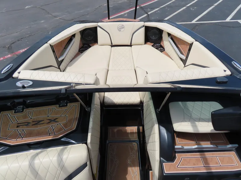 Slide: The Image of 2023 Tigé 24RZX boat interior with luxurious beige seating and stylish wood accents. - 6