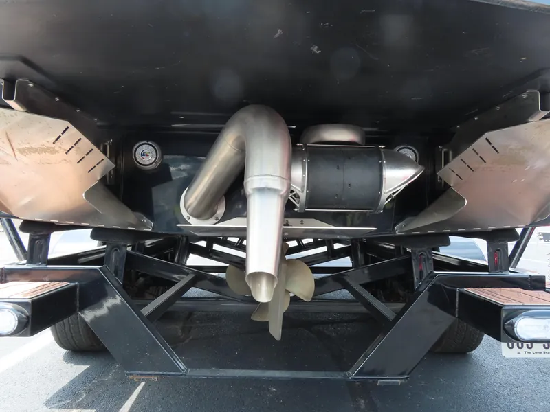 Slide: The Image of Underneath view of a 2023 Tigé 24RZX boat, showcasing exhaust and propeller system. - 8