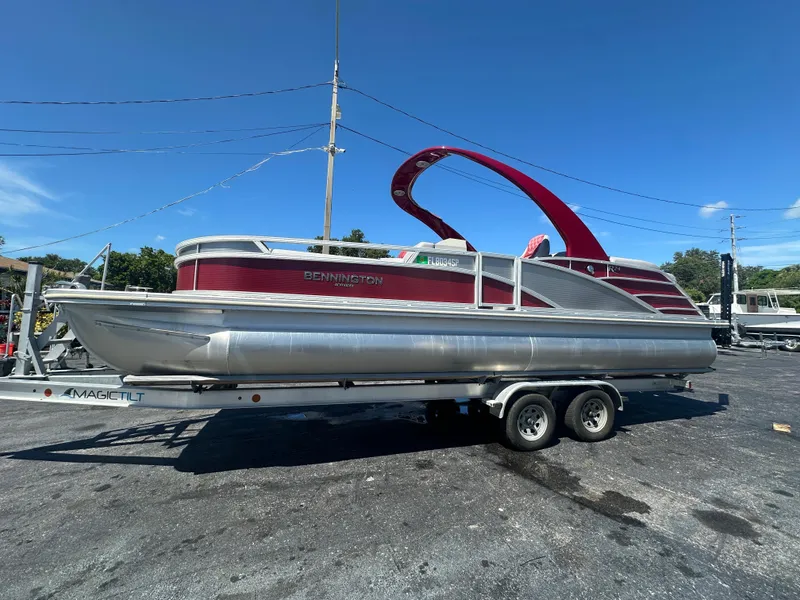 The Image of 2020 Bennington R 24 RTFBA pontoon boat on trailer, red and silver design. - 0