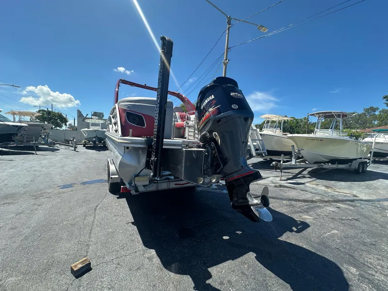 Slide: The Image of 2020 Bennington R 24 RTFBA boat with Yamaha outboard motor in a sunny marina. - 10