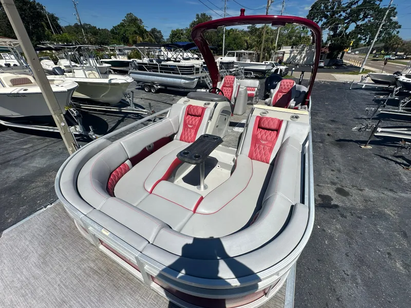 Slide: The Image of 2020 Bennington R 24 RTFBA pontoon boat with red and gray seating, docked outdoors. - 15