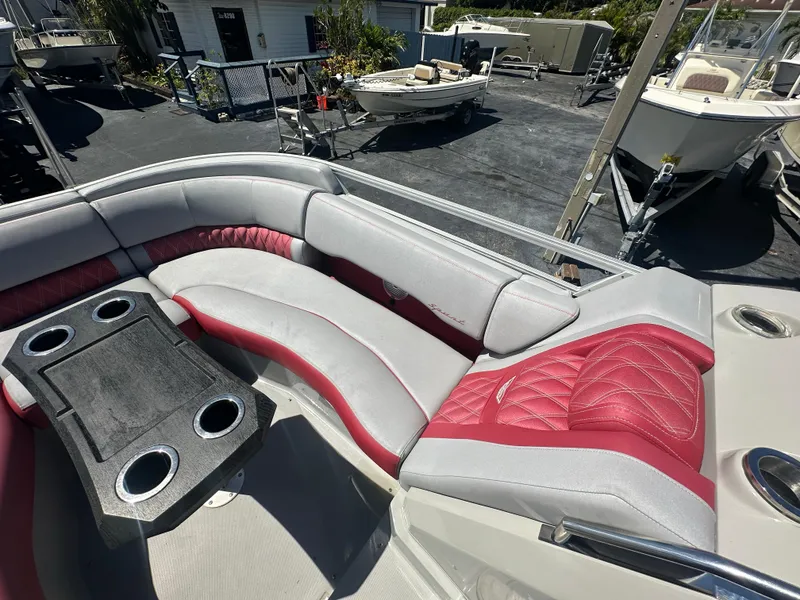 Slide: The Image of 2020 Bennington R 24 RTFBA boat interior with red and gray seating and cup holders. - 20