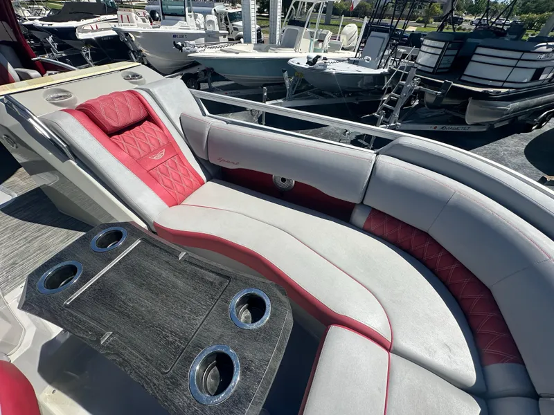 Slide: The Image of Luxurious seating on a 2020 Bennington R 24 RTFBA pontoon boat with red and gray upholstery. - 22