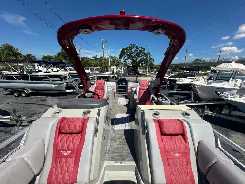 Slide: The Image of 2020 Bennington R 24 RTFBA pontoon boat with red seating and sleek design. - 23