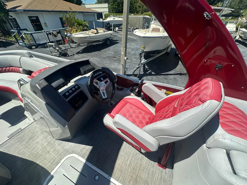 Slide: The Image of 2020 Bennington R 24 RTFBA boat interior with red and gray seating and steering console. - 27