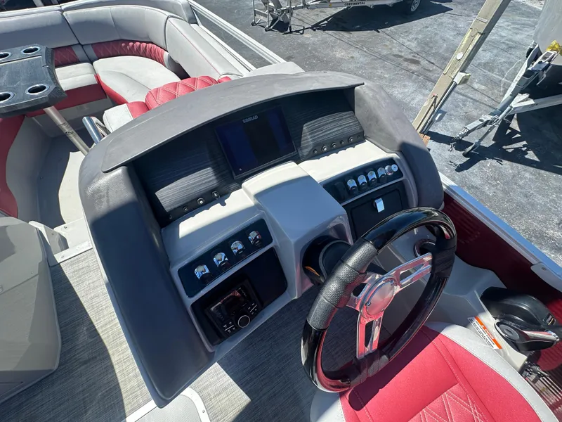 Slide: The Image of 2020 Bennington R 24 RTFBA boat dashboard with steering wheel and seating area. - 28