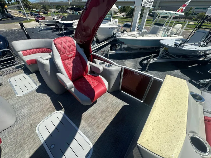 Slide: The Image of 2020 Bennington R 24 RTFBA boat interior with red and gray seating, cup holders, and deck view. - 30