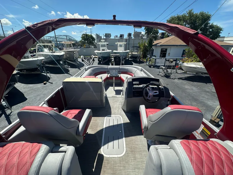 Slide: The Image of 2020 Bennington R 24 RTFBA pontoon boat interior with red and gray seating. - 32