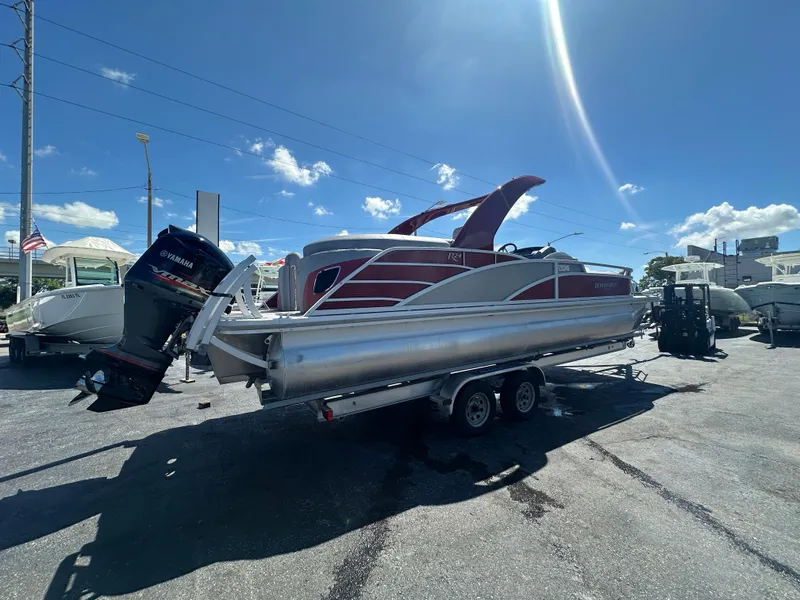 Slide: The Image of 2020 Bennington R 24 RTFBA pontoon boat with Yamaha outboard motor on trailer. - 6
