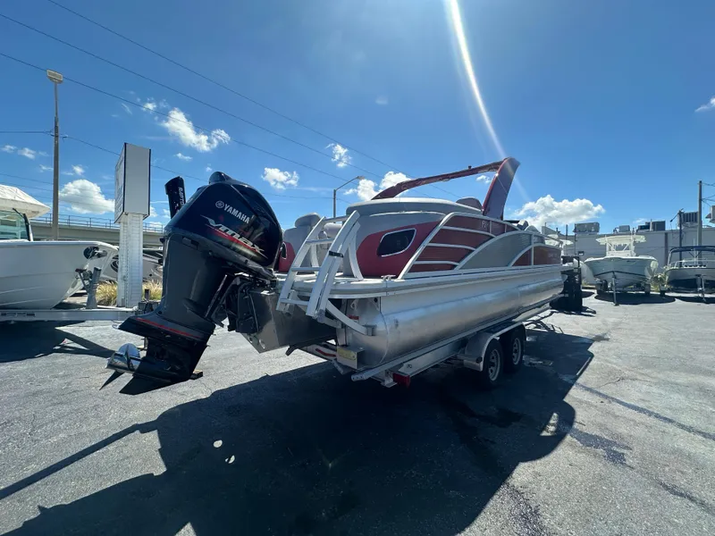 Slide: The Image of 2020 Bennington R 24 RTFBA pontoon boat with Yamaha outboard motor on trailer. - 7