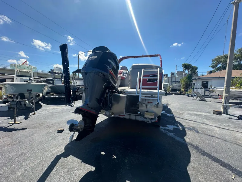 Slide: The Image of 2020 Bennington R 24 RTFBA pontoon boat with Yamaha outboard motor in a sunny marina. - 8